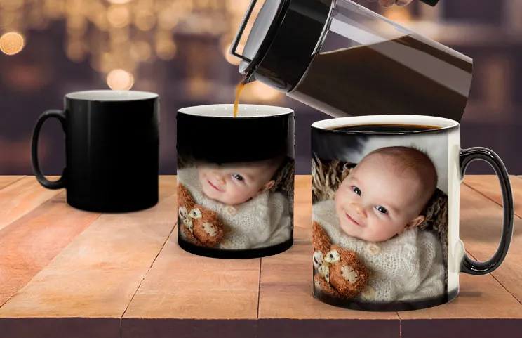 Young boy holding custom designed magic mug with photo of himself on