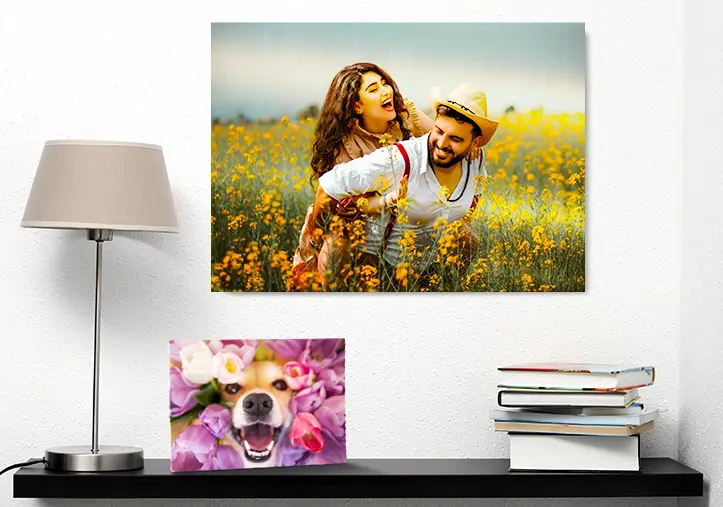 Woman placing metal print of girlfriend and boyfriend on wall