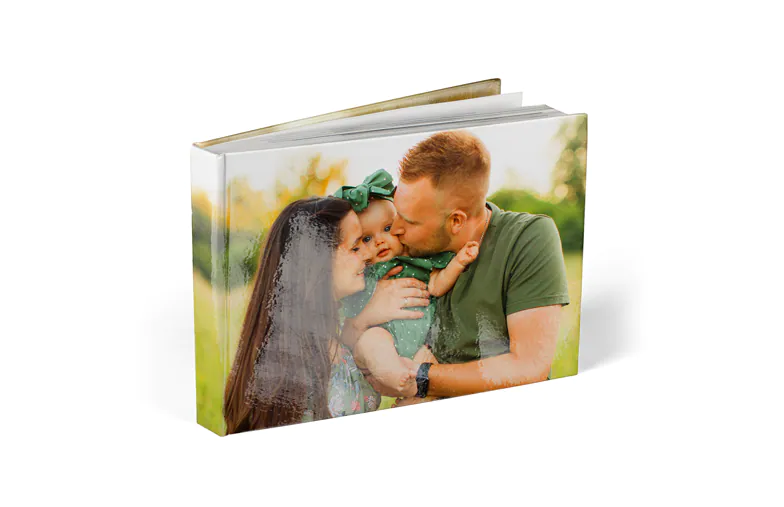 Photo Books|Photo Books|Personalised photo album book with romantic pictures of a couple and photo cover|Family photo album with custom printed cover and family name text|Pet and woman looking at personalised family photo book with custom design|Two people looking at Printerpix custom photo book with wedding photos and bride|||||