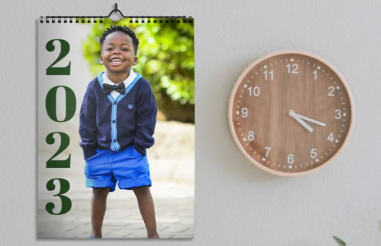 Girlfriend photo on personalised wall calendar hung up in living room